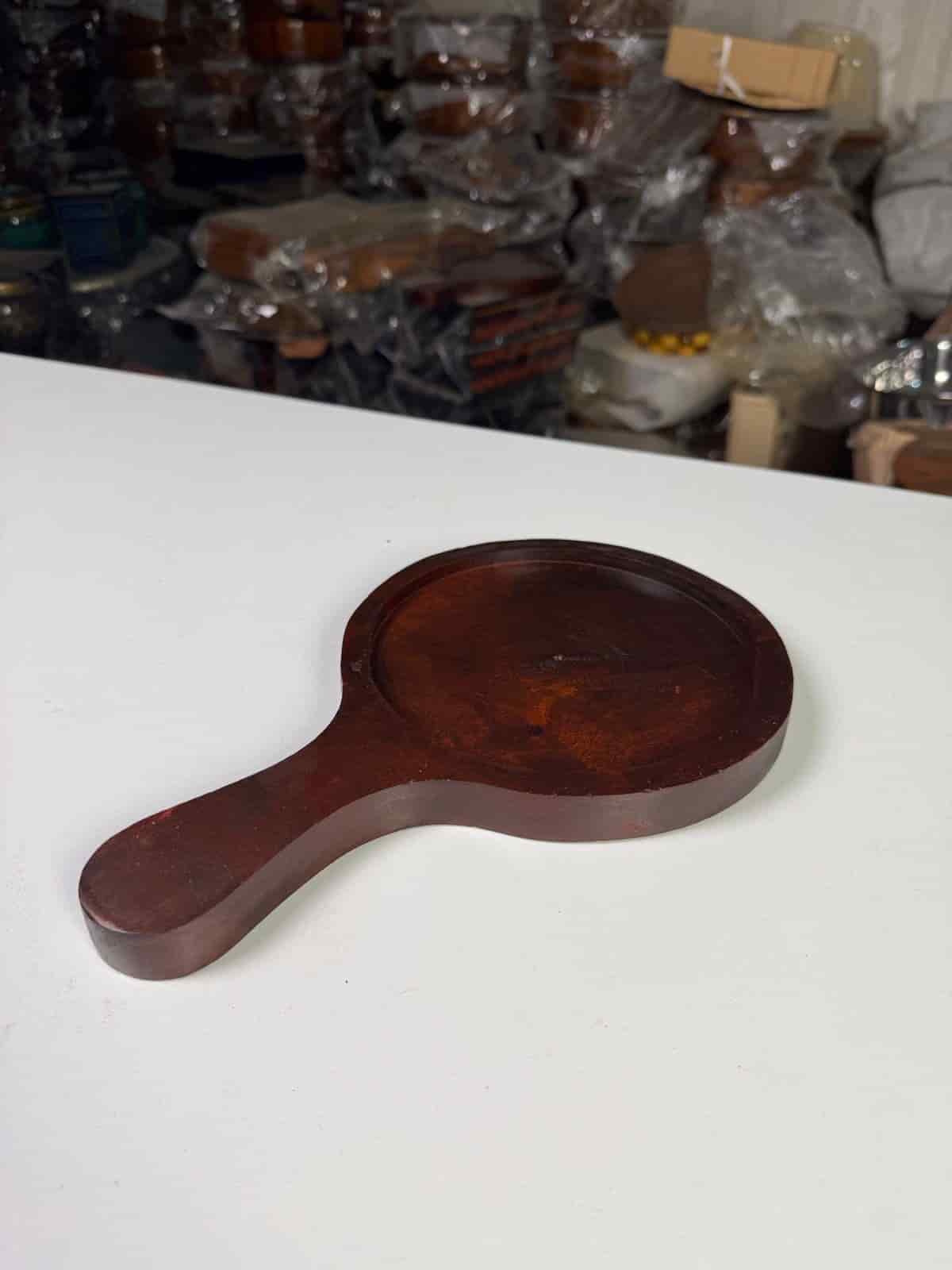 Non-stick pizza pan with handle on a countertop with a freshly baked pizza

